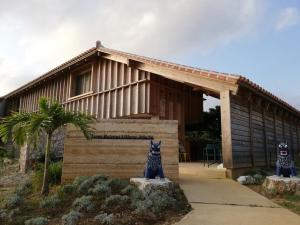 a house with two cat statues in front of it at Yoga Retreat Village, kSaNa - Vacation STAY 95928v in Nagura