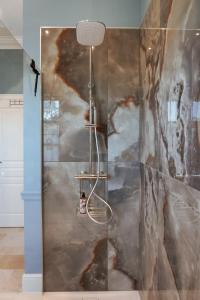 a shower in a room with a painting on the wall at Château de la Tour in Romanèche-Thorins +32 photos