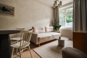 una sala de estar con un sofá y una mesa en Limewash Apartments Karlsbad, en Karlovy Vary