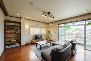 a living room with a couch and a table at Kawashiri no Tomari - Vacation STAY 17885v in Kumamoto