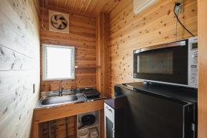 a small kitchen with a sink and a microwave at Kawashiri no Tomari - Vacation STAY 17885v in Kumamoto