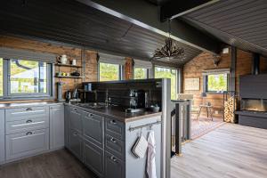 a kitchen with a stove top oven in a cabin at Fagertoppen 1314B by Vacation Trysil in Mælem