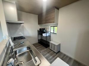 a small kitchen with a sink and a stove at Fabulous Shiroyama - Vacation STAY 17734 in Odawara