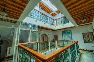 a large staircase in a house with wooden ceilings at RIAD LA SANTA in Chefchaouen