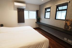a bedroom with a white bed and two windows at Akikawa Villas1 - Vacation STAY 18834 in Yuge