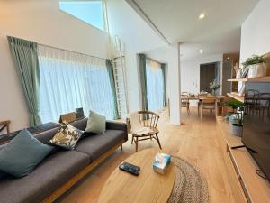 a living room with a couch and a table at Akikawa Villas 4 - Vacation STAY 18837 in Yuge
