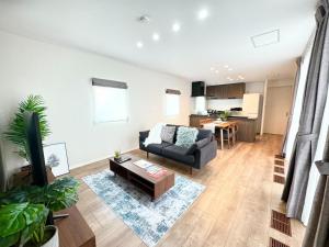 a living room with a couch and a table at Akikawa Villas 8 - Vacation STAY 18841 in Yuge