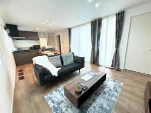 a living room with a couch and a table at Akikawa Villas 8 - Vacation STAY 18841 in Yuge +6 photos