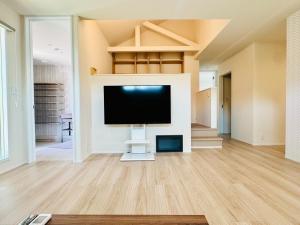 a living room with a flat screen tv on a wall at Akikawa Villas 12 - Vacation STAY 18845 in Fukumoto
