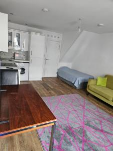 a kitchen and a living room with a couch at Northampton RoomKey in Northampton