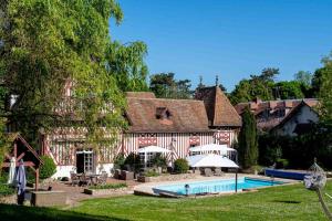 a house with a swimming pool in front of it at Marquise Barbot in Courcouronnes