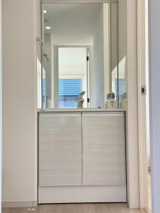 a bathroom with a sink and a mirror at Akikawa Villas14 - Vacation STAY 18847 in Fukumoto