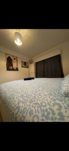 a bedroom with a bed with a blue comforter at Chambre ROOM 1 in Dilbeek +3 photos