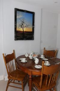 a dining room table with chairs and a mirror at Coaches Corner - Accessible Self-Catering Guest Suite - 5 Minutes from town - Singles or Super-King in Castleblayney