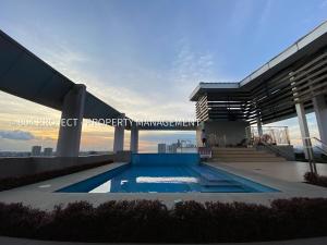 a swimming pool on the roof of a building at 1BR at Vinia Residences, North EDSA, QC in Manila
