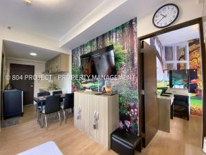 a living room with a clock on a wall at 1BR at Vinia Residences, North EDSA, QC in Manila