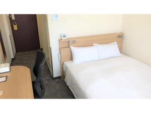 a hotel room with a bed and a desk and a table at Smile Hotel Kumagaya - Vacation STAY 90007v in Kumagaya