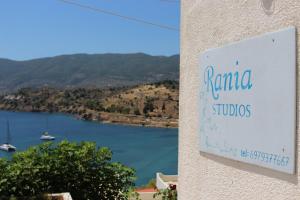 a sign for a building with a view of a lake at Rania Studios in Poros