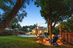 a group of chairs sitting in a yard at Heated Pool Grill Fire Pit & Cold Plunge Sleeps 8! in West Palm Beach
