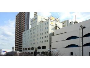 a large white building in front of tall buildings at Smile Hotel Shimonoseki - Vacation STAY 96732v in Shimonoseki +12 photos