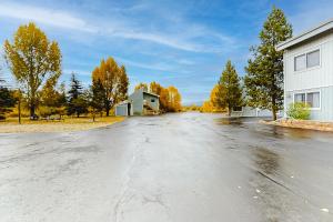 an empty street with a building and trees at Twin Rivers 3 in Fraser