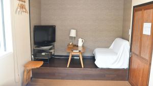 a hotel room with a bed and a tv at Minshuku Misakiso - Vacation STAY 89779v in Miyazaki