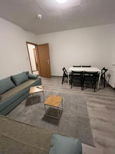 a living room with a couch and a table at Monteurswohnung Wilhelmshafen in Wilhelmshaven