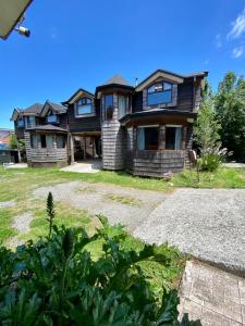 a large house with a driveway in front of it at Cabañas Estacion del Lago in Puerto Varas