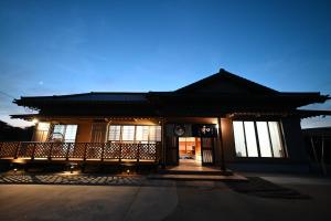 a building with a porch with lights on it at Japanese Light - Vacation STAY 00130v 