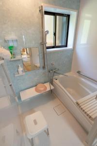 a bathroom with a tub and a toilet and a sink at Kawasuesantaku "Koppa） - Vacation STAY 02876v in Goto