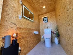 a bathroom with a toilet in a stone wall at Rasta Camp Hakushu - Vacation STAY 03222v in Shirasu