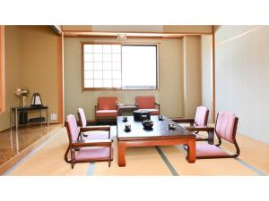 a conference room with a table and chairs and a window at Komakusa Hotel - Vacation STAY 03263v in Matsumoto