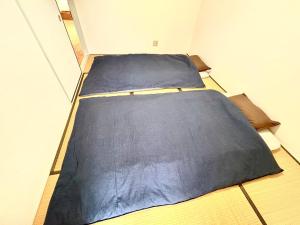two beds in a small room with at Rodman TONE A102 - Vacation STAY 06233v in Kitakyushu