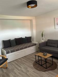 a living room with a couch and a table at Ferienhaus an der Ostsee in Ratekau