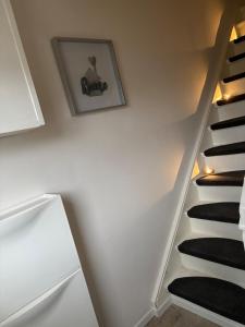 a staircase in a room with white walls and black carpet at Ferienhaus an der Ostsee in Ratekau