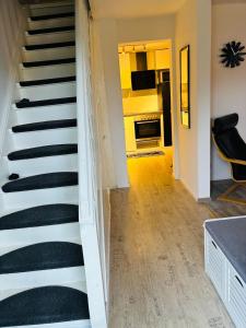 a staircase leading to a living room and a kitchen at Ferienhaus an der Ostsee in Ratekau