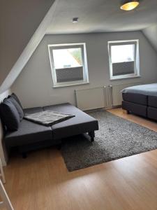 a living room with a bed and a couch at Ferienhaus an der Ostsee in Ratekau
