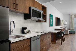 a kitchen with a sink and a microwave at TownePlace Suites by Marriott Ventura Oxnard in Oxnard