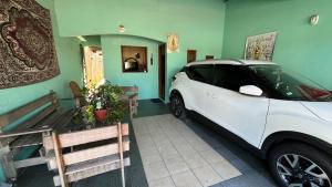 a white car is parked in a garage at Casa Cop30 green zone in Belém