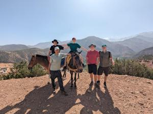a group of people with a woman on a horse on a hill at Dar Imoughlad in Marrakesh