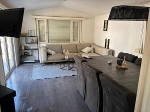 a living room with a table and a couch at Chalet Heische tip in Zeeland
