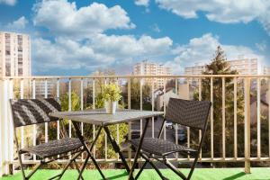 un tavolo e due sedie su un balcone di Cocooning 7mn Metro Proche Paris a Bagneux