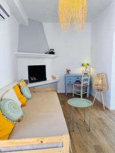 a bedroom with a large bed and a table at Villa Kastrouna, with private heated jacuzzi in Symi