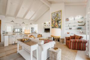 a living room with a couch and a table at Comporta Sunset Villa by Lovelystay in Comporta