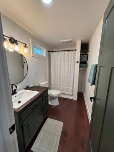 a bathroom with a sink and a toilet and a mirror at Lake Eagle Rock Lodge in Eagle Rock
