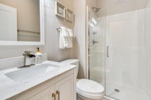 a white bathroom with a sink and a shower at Mtn Views and Stunning Fall Hikes Maggie Valley Apt in Maggie Valley +19 photos