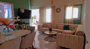 a living room with a couch and a table at Secrète Paradise in Capesterre-Belle-Eau