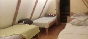 a room with three beds in a room at IvanA vikendica,Krupa na Vrbasu in Banja Luka