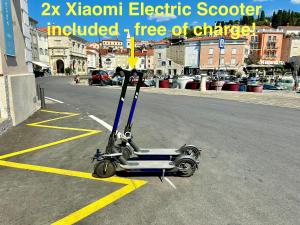 a scooter parked in the middle of a street at Grand Apartment Piran in Piran