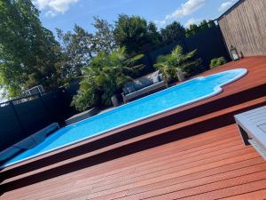a swimming pool on the side of a house at B&B by Delizia met mogelijkheid tot bijhuren van privé wellness in Rumst